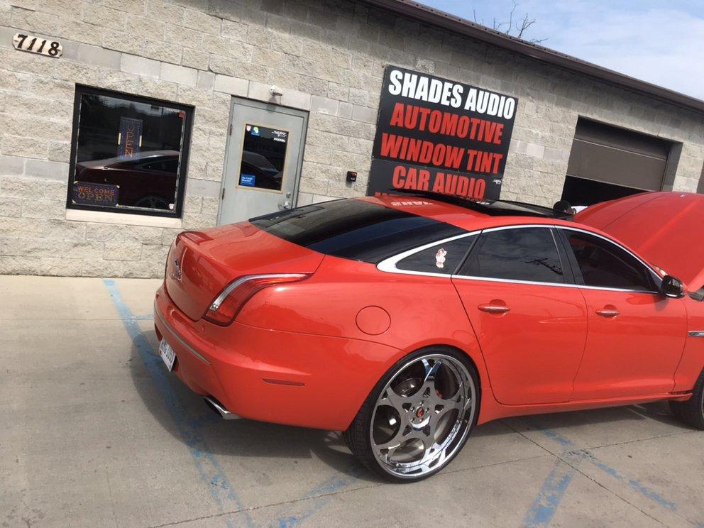 Red Jaguar XJ with window tint and custom wheels