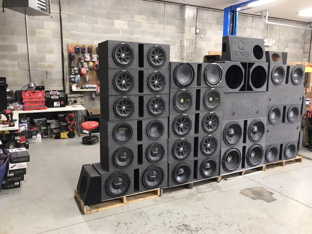 Wall of Kicker, Kenwood and Skar subwoofer enclosures